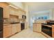 Modern kitchen with light wood cabinets, granite countertops, and stainless steel appliances at 1520 Symphony Hts, Monument, CO 80132