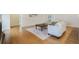 Cozy living room with hardwood floors, decorative rug, and comfortable white seating at 1520 Symphony Hts, Monument, CO 80132