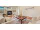 Bright living room with fireplace, hardwood floors, and comfortable seating at 1520 Symphony Hts, Monument, CO 80132