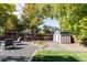 Landscaped backyard with shed, raised garden, and patio seating at 2719 S Truckee St, Aurora, CO 80013