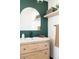 Modern bathroom with dark green walls and light wood vanity at 2719 S Truckee St, Aurora, CO 80013