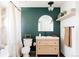 Modern bathroom with dark green walls and light wood vanity at 2719 S Truckee St, Aurora, CO 80013