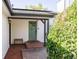 Inviting front porch featuring a brick pathway, olive green door, and lush landscaping at 2719 S Truckee St, Aurora, CO 80013