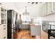 Modern kitchen with stainless steel appliances and light wood floors at 2719 S Truckee St, Aurora, CO 80013