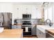 Bright kitchen with stainless steel appliances, patterned backsplash, and butcher block countertops at 2719 S Truckee St, Aurora, CO 80013