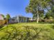 Spacious backyard featuring lush lawn, deck, and mature trees at 9540 King Way, Westminster, CO 80031