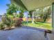 Covered backyard patio with lush garden and a wooden privacy fence at 9540 King Way, Westminster, CO 80031