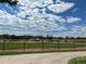 View of the community baseball field from behind the fence, featuring green grass and well-maintained facilities at 9540 King Way, Westminster, CO 80031