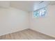 Finished basement with light wood flooring and bright window view at 9540 King Way, Westminster, CO 80031