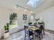 Cozy dining room with large windows, a skylight, and access to outdoor views at 9540 King Way, Westminster, CO 80031