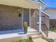 Inviting front porch with brick facade, stylish door, and modern lighting at 9540 King Way, Westminster, CO 80031