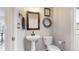 Small powder room with pedestal sink and decorative accents at 4192 Aspenmeadow Cir, Highlands Ranch, CO 80130