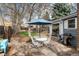 Inviting backyard with a stone patio, dining area, and well-maintained landscaping for outdoor entertaining at 7142 S Hudson Ln, Centennial, CO 80122