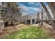 A spacious backyard featuring a covered patio, a brick fireplace chimney, and lush green grass at 7142 S Hudson Ln, Centennial, CO 80122