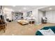 Finished basement with tan carpeting, showcasing a cozy living area and recreational space at 7142 S Hudson Ln, Centennial, CO 80122