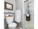 Clean bathroom featuring a glass-enclosed shower, toilet, and functional storage at 7142 S Hudson Ln, Centennial, CO 80122