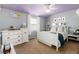 Cozy bedroom with a lilac ceiling, white furniture, and bright natural light at 7142 S Hudson Ln, Centennial, CO 80122