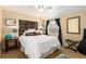 Comfortable bedroom features a decorative headboard, plush bedding, and natural lighting at 7142 S Hudson Ln, Centennial, CO 80122