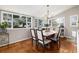 Bright dining area featuring a large dining table surrounded by windows and flooded with natural light at 7142 S Hudson Ln, Centennial, CO 80122