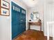 Inviting entryway with teal double doors, terra cotta tile flooring, and decorative accents at 7142 S Hudson Ln, Centennial, CO 80122