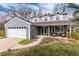 Charming two-story home with blue siding, white trim, and a well-manicured front yard at 7142 S Hudson Ln, Centennial, CO 80122
