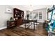 Bright home office with hardwood floors, a large window, and a built-in bookcase at 7142 S Hudson Ln, Centennial, CO 80122