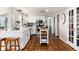 Well-lit kitchen featuring terracotta tile flooring, white cabinetry, and a central island with butcher block top at 7142 S Hudson Ln, Centennial, CO 80122