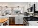 Kitchen with tile countertops and stainless steel appliances, including a dishwasher and gas range at 7142 S Hudson Ln, Centennial, CO 80122