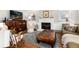 Comfortable living room featuring a fireplace, decorative furnishings, and a gray rug with exposed terracotta tile flooring at 7142 S Hudson Ln, Centennial, CO 80122