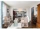 Open-concept living space featuring hardwood floors, comfortable seating, and a home office beyond at 7142 S Hudson Ln, Centennial, CO 80122
