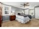 Serene main bedroom boasts a plush bed, ceiling fan, and natural light from the windows at 7142 S Hudson Ln, Centennial, CO 80122