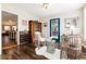 Inviting sitting room with hardwood floors, decorative chairs, and a wine rack in the background at 7142 S Hudson Ln, Centennial, CO 80122