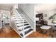 Elegant staircase with black treads, white risers and rails, leading to an office space at 7142 S Hudson Ln, Centennial, CO 80122