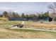 A tennis court is surrounded by mature trees and lush landscaping, with a bridge at 7142 S Hudson Ln, Centennial, CO 80122
