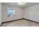 Bright room with wood-look flooring, a window with blinds, and neutral wall color at 1135 S Gilbert St # 103, Castle Rock, CO 80104
