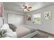 Stylishly furnished bedroom with modern decor, a ceiling fan, and ample natural light at 1135 S Gilbert St # 103, Castle Rock, CO 80104