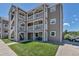 Exterior view of a multi-story home with private balconies and landscaped grounds at 1135 S Gilbert St # 103, Castle Rock, CO 80104