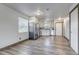 Open kitchen with stainless steel appliances and white cabinetry, seamlessly connecting to the living area at 1135 S Gilbert St # 103, Castle Rock, CO 80104