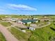 Aerial view of a horse farm featuring multiple barns, paddocks, a horse trailer, and a pristine green landscape at 39681 Swift Creek Cir, Elizabeth, CO 80107