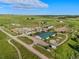 Expansive aerial view of a horse farm with paddocks, barns, outbuildings, and a well-maintained landscape at 39681 Swift Creek Cir, Elizabeth, CO 80107