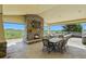 Back patio with a stone fireplace and views of the surrounding countryside at 39681 Swift Creek Cir, Elizabeth, CO 80107