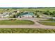 Aerial view of a barn with multiple bays surrounded by well-manicured grounds, fencing, and open fields at 39681 Swift Creek Cir, Elizabeth, CO 80107