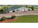 Close up of barn featuring multiple bays, American flags, fresh landscaping, and an inviting entrance at 39681 Swift Creek Cir, Elizabeth, CO 80107