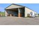 This barn features a gravel driveway and a trailer outside the entrance at 39681 Swift Creek Cir, Elizabeth, CO 80107