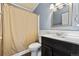 Bathroom with a vanity sink, toilet and shower with a beige curtain at 39681 Swift Creek Cir, Elizabeth, CO 80107