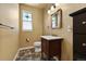 Half bath featuring a charming window and decorative mirror at 39681 Swift Creek Cir, Elizabeth, CO 80107