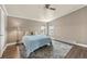 Cozy bedroom featuring hardwood floors, neutral walls, ceiling fan and two windows at 39681 Swift Creek Cir, Elizabeth, CO 80107