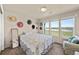 Bright bedroom with many windows, a floral-themed bed and an accent chair at 39681 Swift Creek Cir, Elizabeth, CO 80107