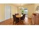 Cozy dining room with hardwood floors, a chandelier, and sliding glass doors to the outdoor patio at 39681 Swift Creek Cir, Elizabeth, CO 80107
