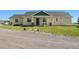 Charming single-story home with a covered porch, stone accents, and a well-maintained lawn with stepping stones at 39681 Swift Creek Cir, Elizabeth, CO 80107